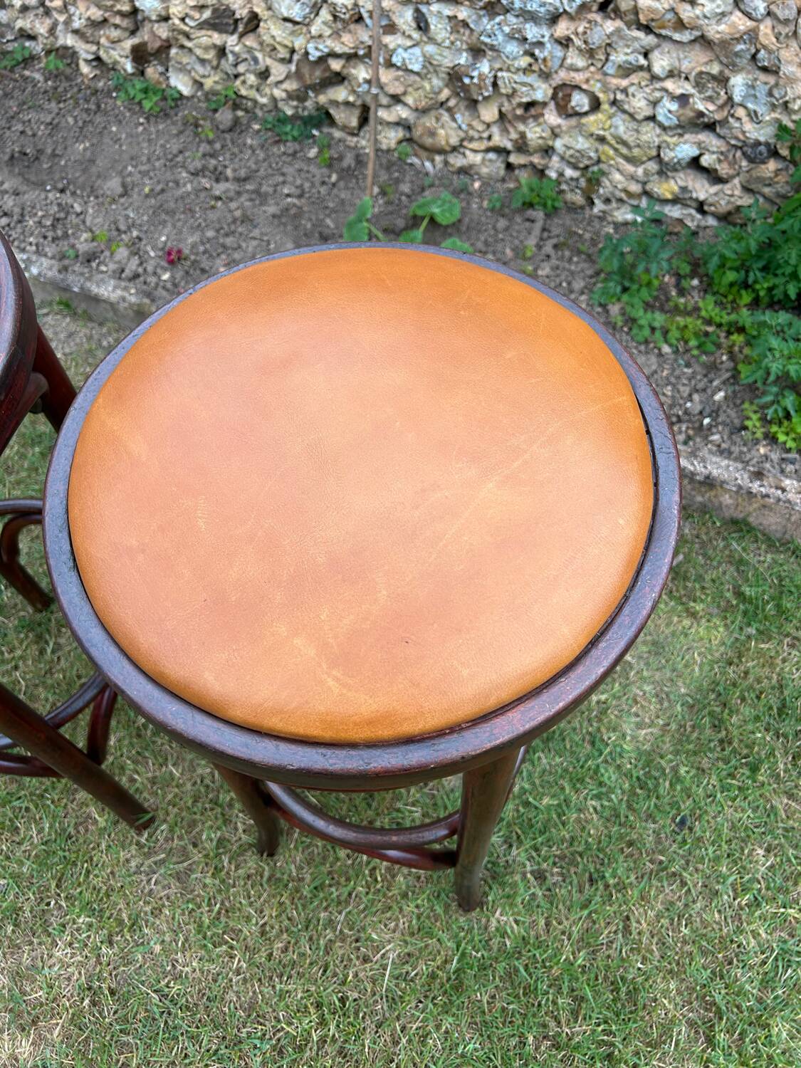 Pair of curved wooden bistro stools with leather seats