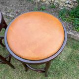 Pair of curved wooden bistro stools with leather seats