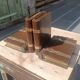 Wooden trompe-l'œil bookends with a book and box