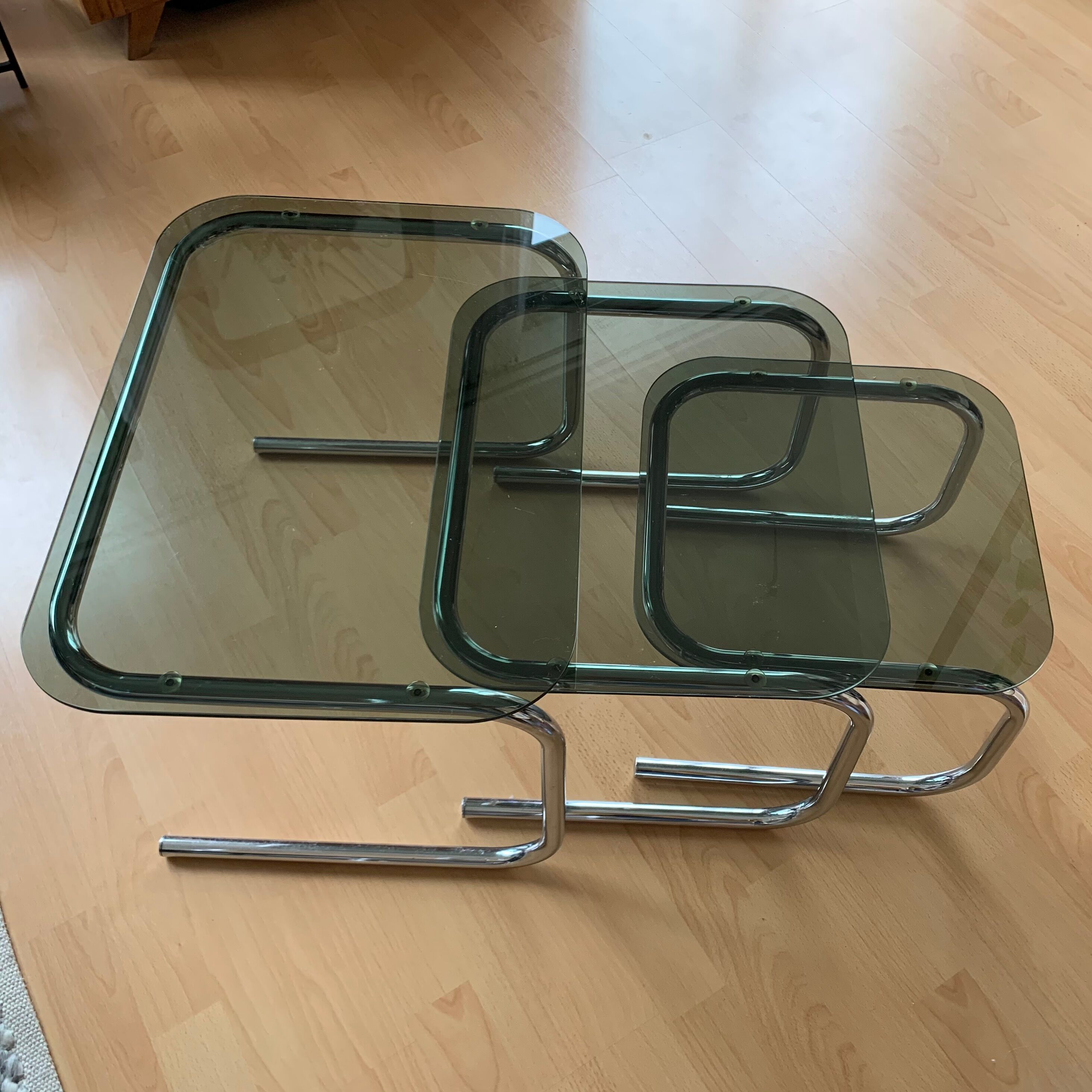 Pull out tables in chrome metal & smoked glass