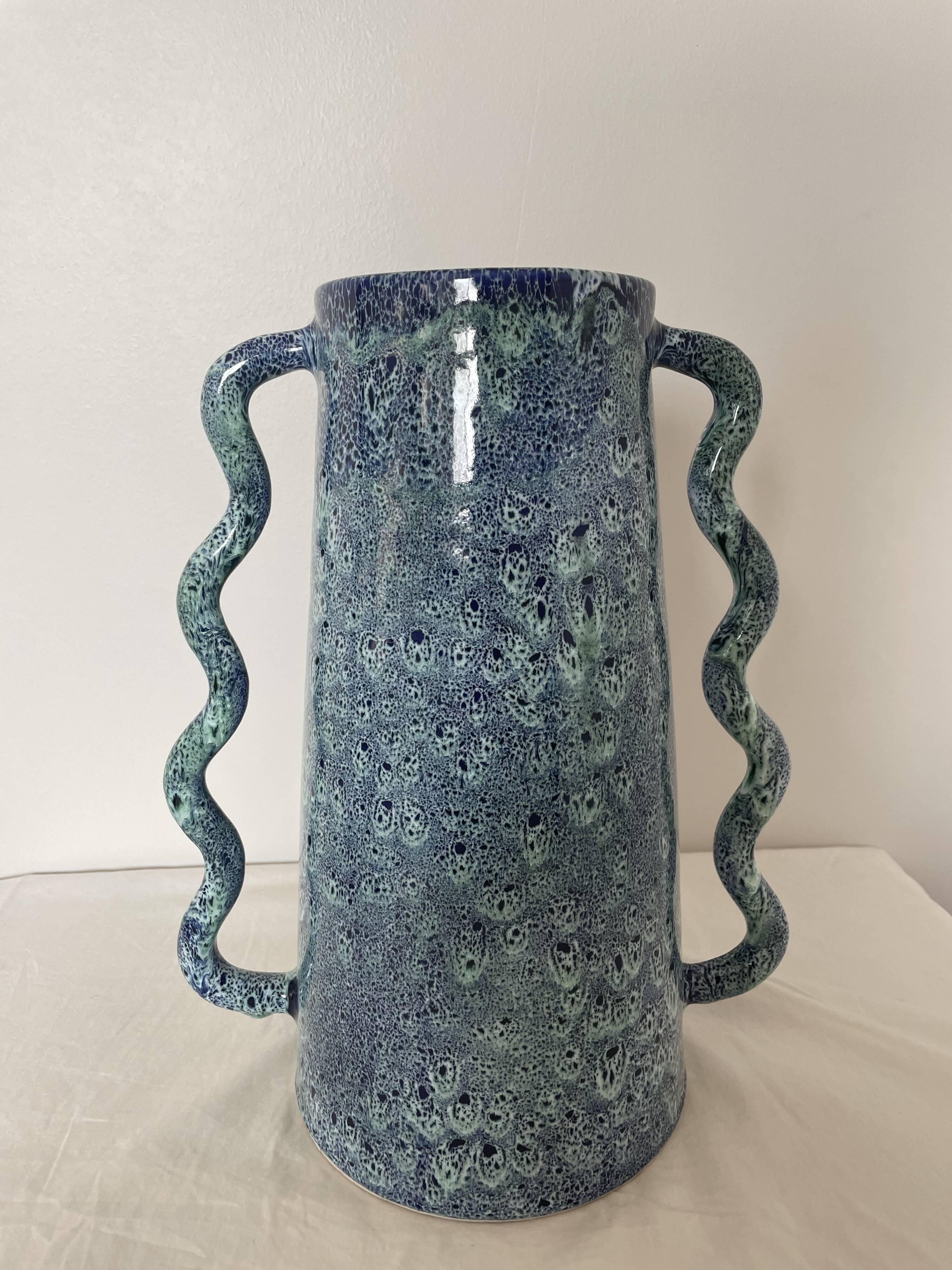 Blue-green ceramic vase with abstract wavy handles