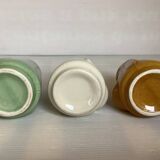 Set of three small Moai-style head vases.