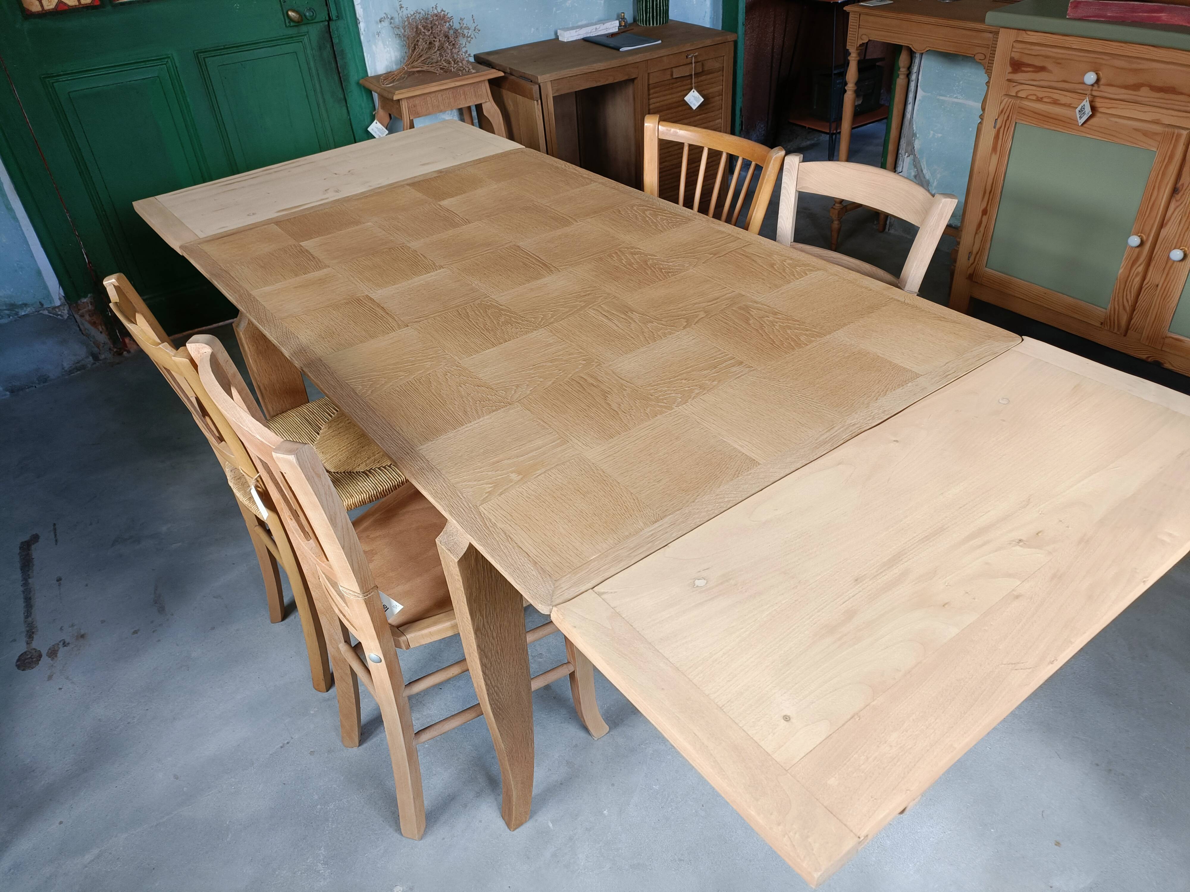Oak dining table with a checkerboard top and extensions.