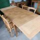 Oak dining table with a checkerboard top and extensions.
