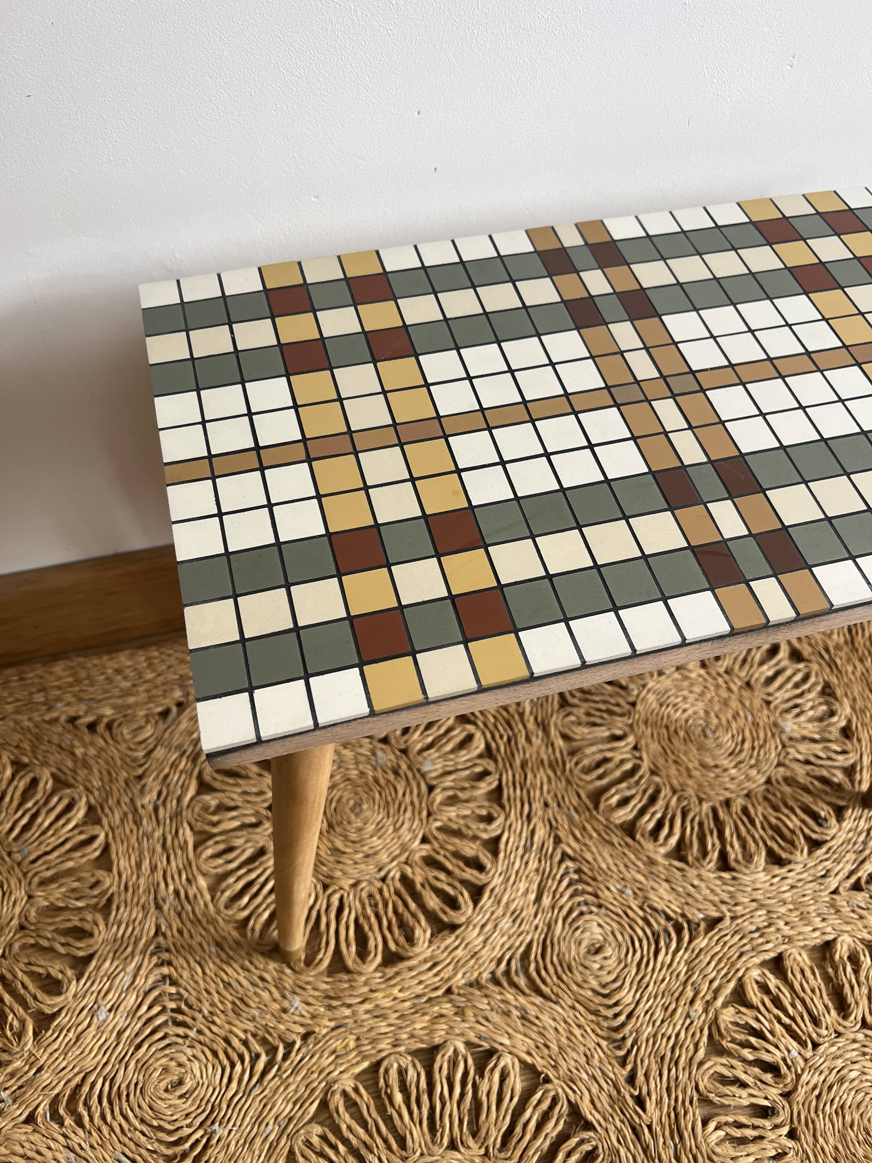 Small mosaic bedside table with tapered legs.