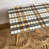 Small mosaic bedside table with tapered legs.