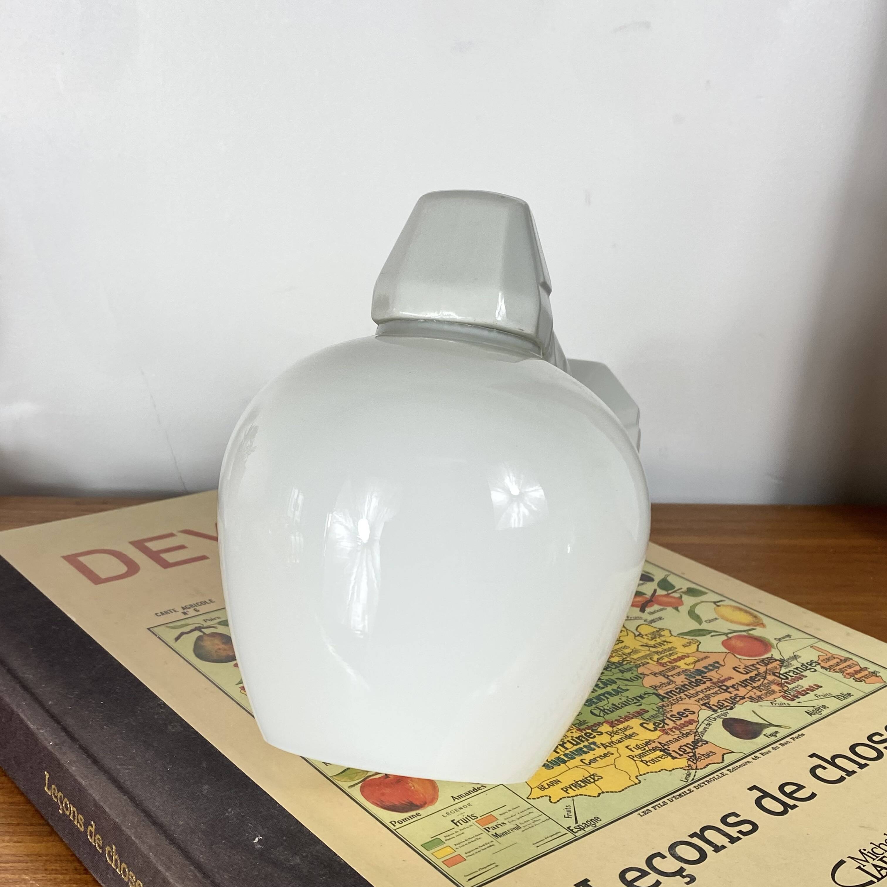 Swan neck wall light in ceramic with an opaline white glass globe.