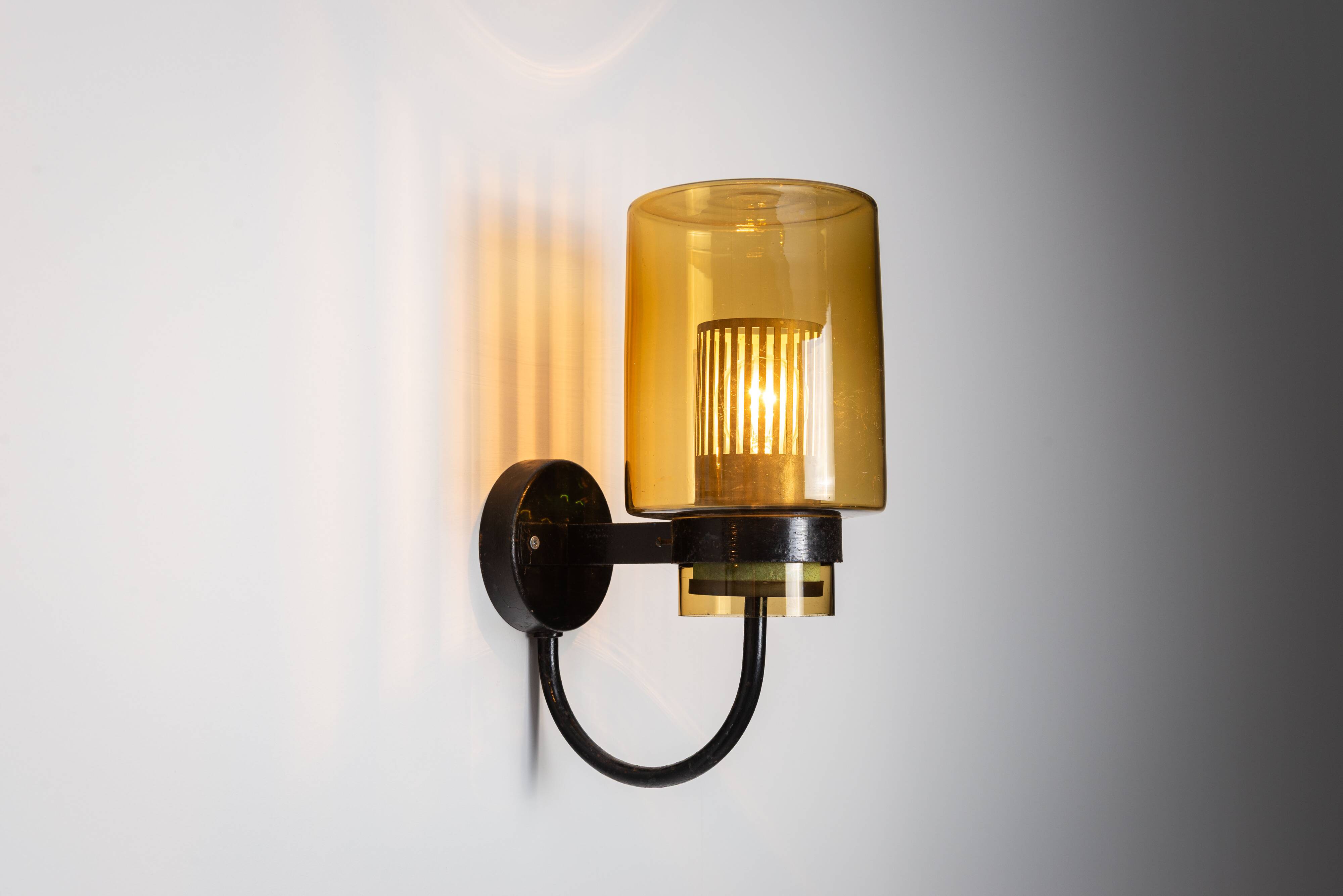 Pair of black metal wall lamps with yellow shades and inner diffuser