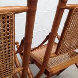 Pair of folding chairs in bamboo and caning, leather and brass