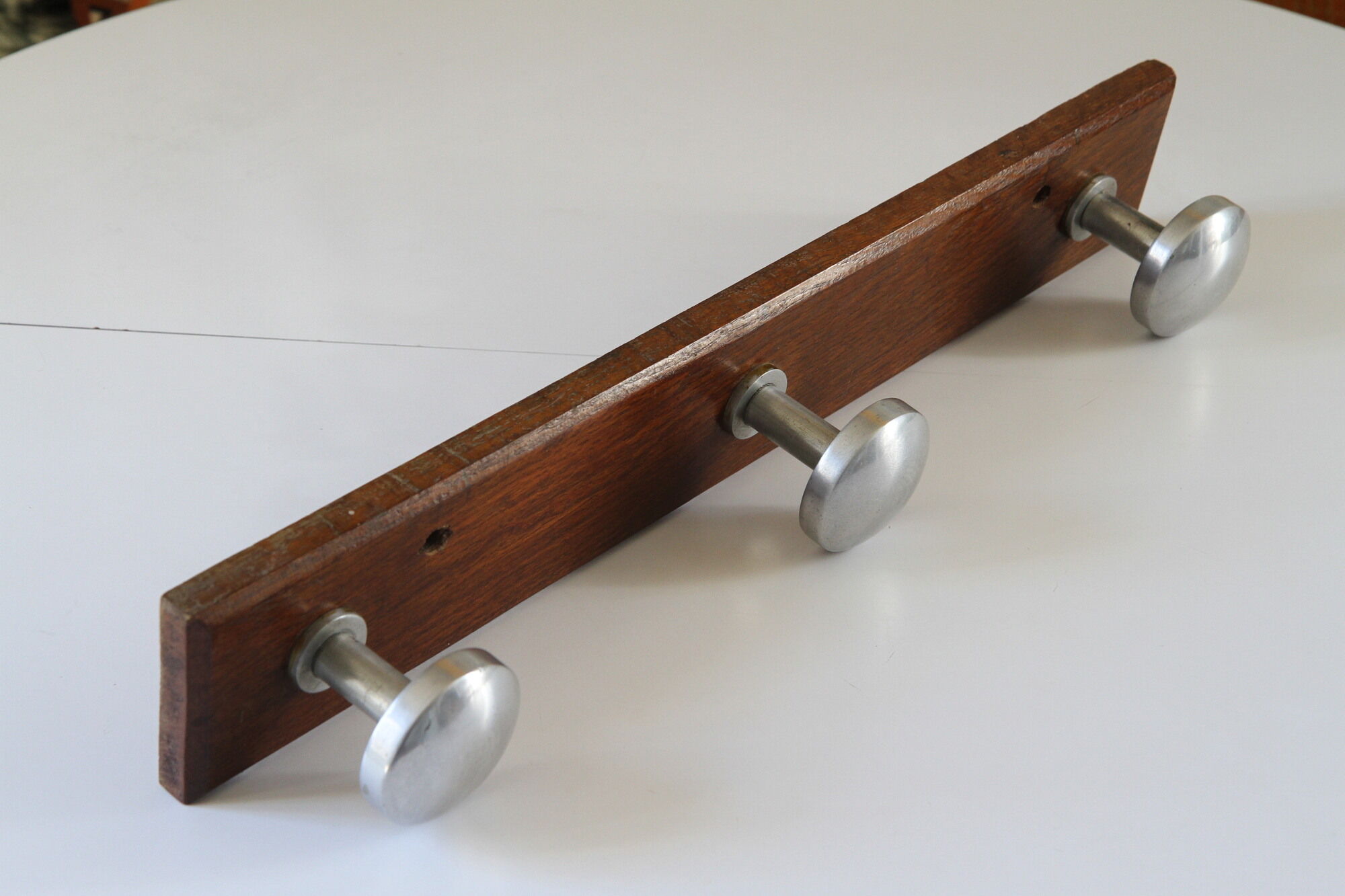 Wooden and stainless steel coat holders from the 1920s