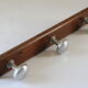 Wooden and stainless steel coat holders from the 1920s