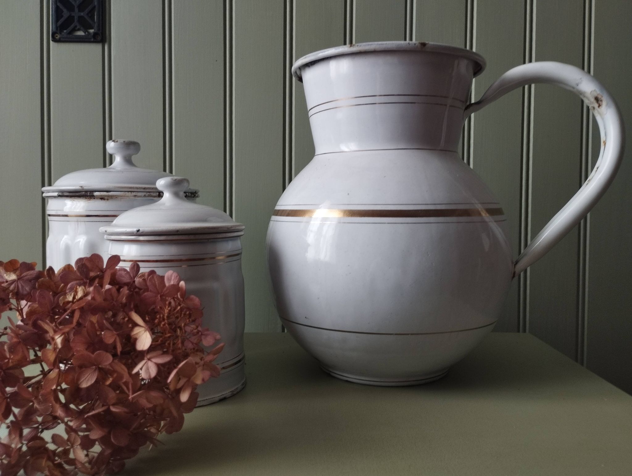 Rare large, pot-bellied toilet jug in white enamelled sheet metal with gold edging