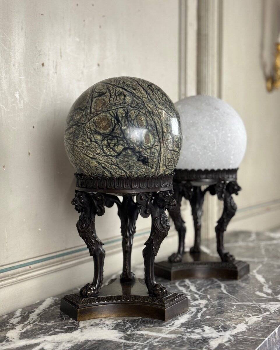 Pair of marble spheres on bronze tripods, 19th century