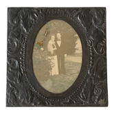 Old photo holder frame in vintage chiseled pewter