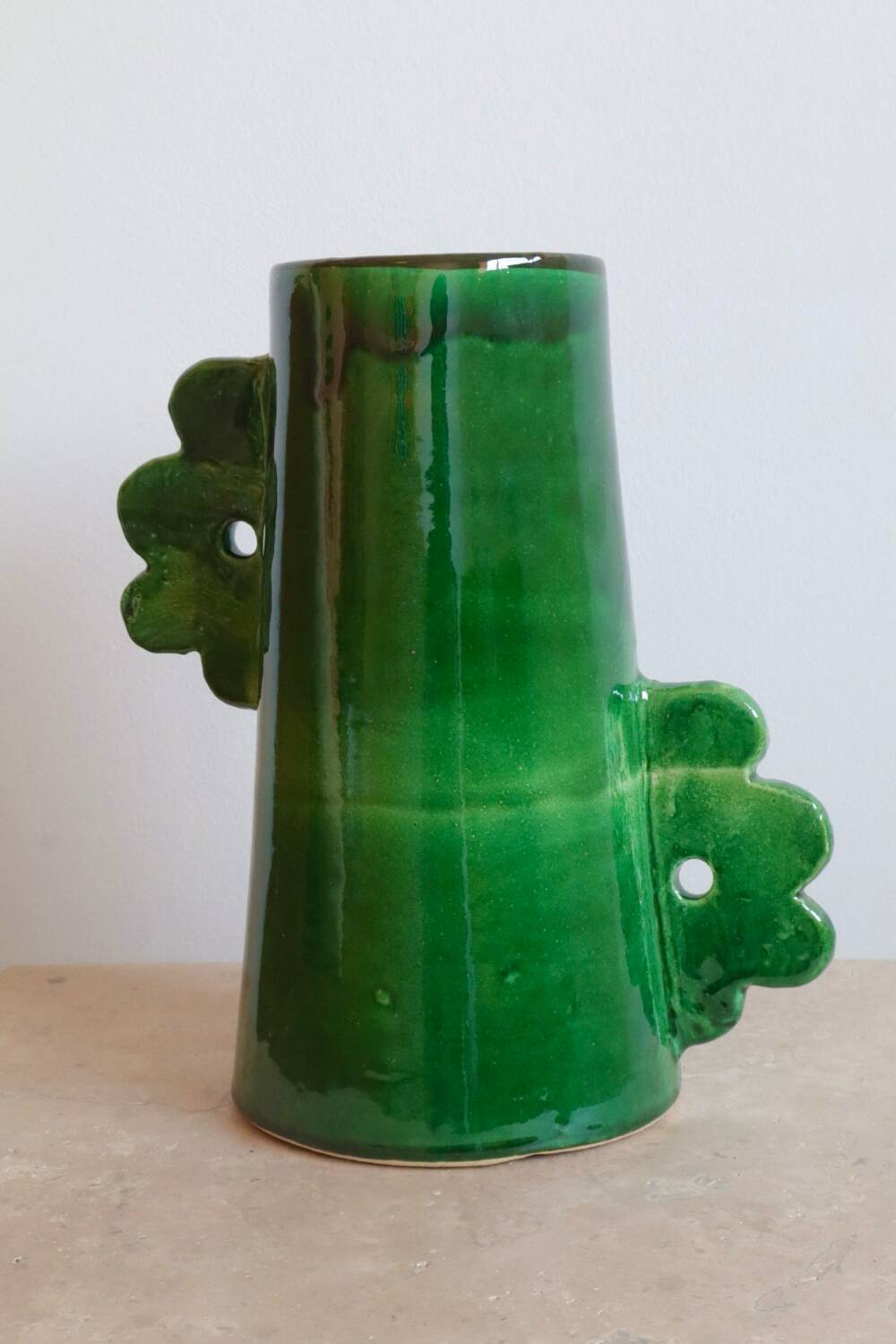 Handmade ceramic abstract vase with asymmetrical handles and fir green flowers