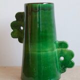 Handmade ceramic abstract vase with asymmetrical handles and fir green flowers