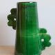 Handmade ceramic abstract vase with asymmetrical handles and fir green flowers
