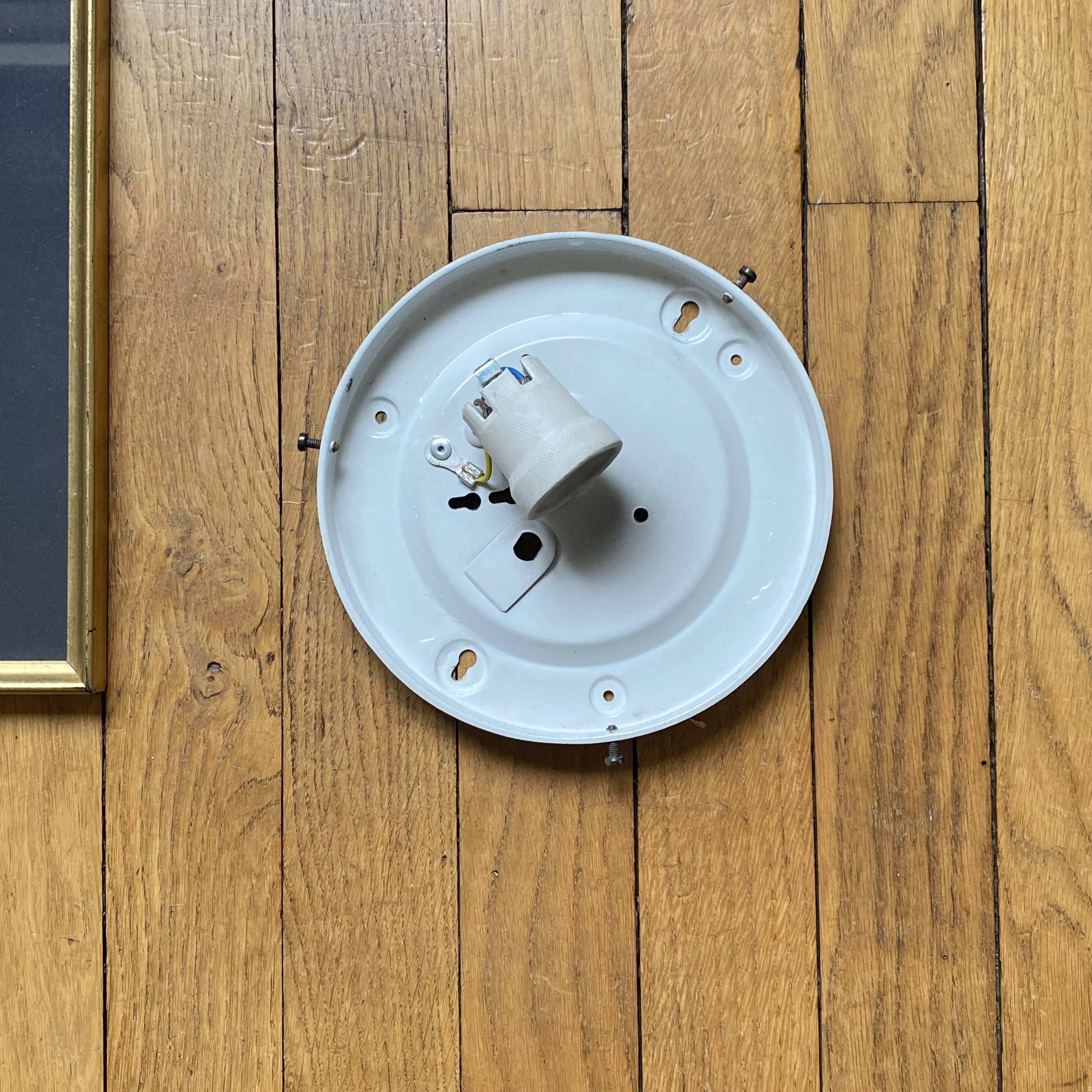 Large wall-mounted ceiling light with transparent glass.