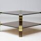 Hollywood Regency coffee table in brass and smoked glass, chic two-tier coffee table.
