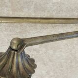 Adjustable wall light in brass and gold metal.