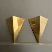 Pair of geometric vintage wall lamps in solid brass, France 1970.