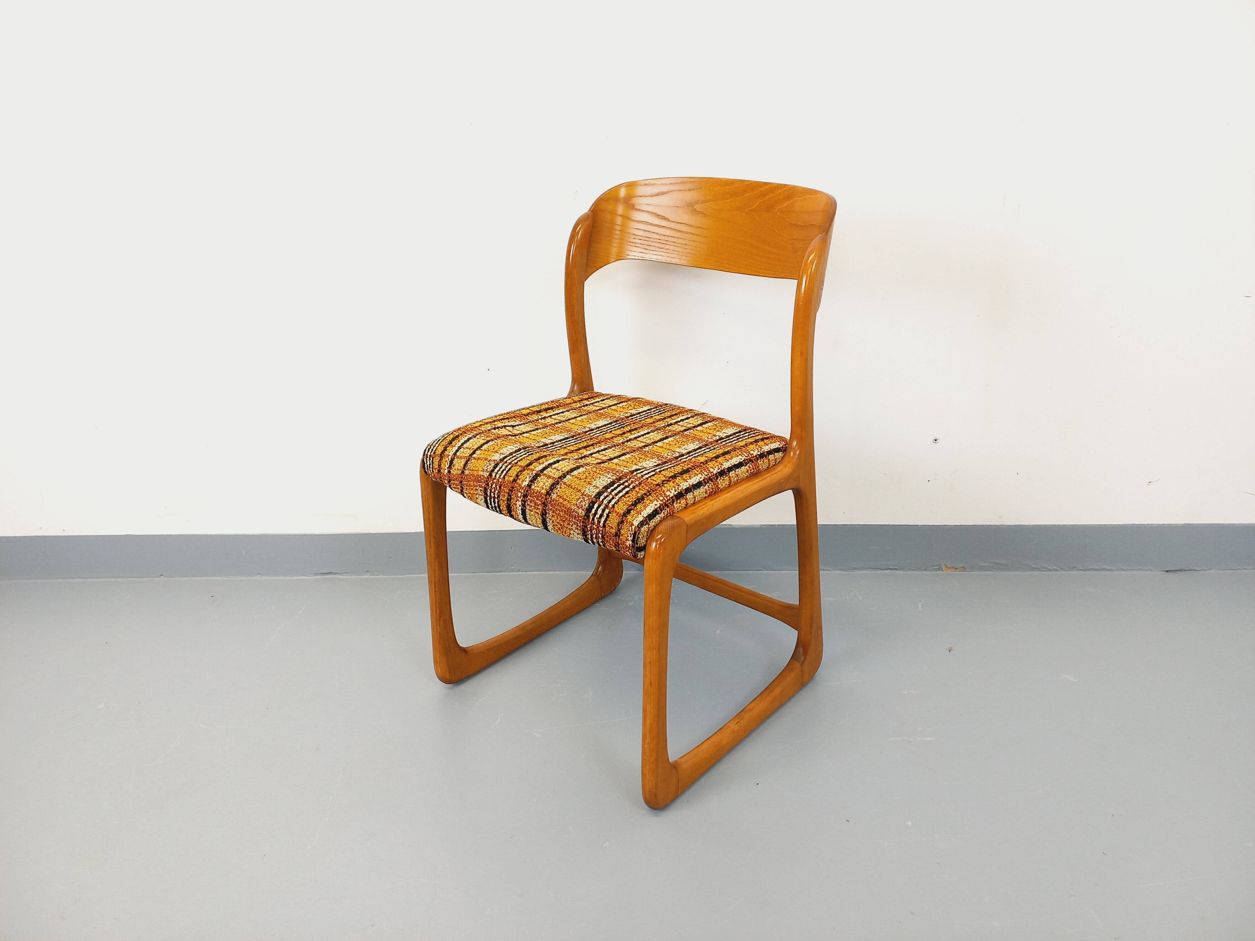 Vintage sled chair by Baumann in wood and wool fabric.