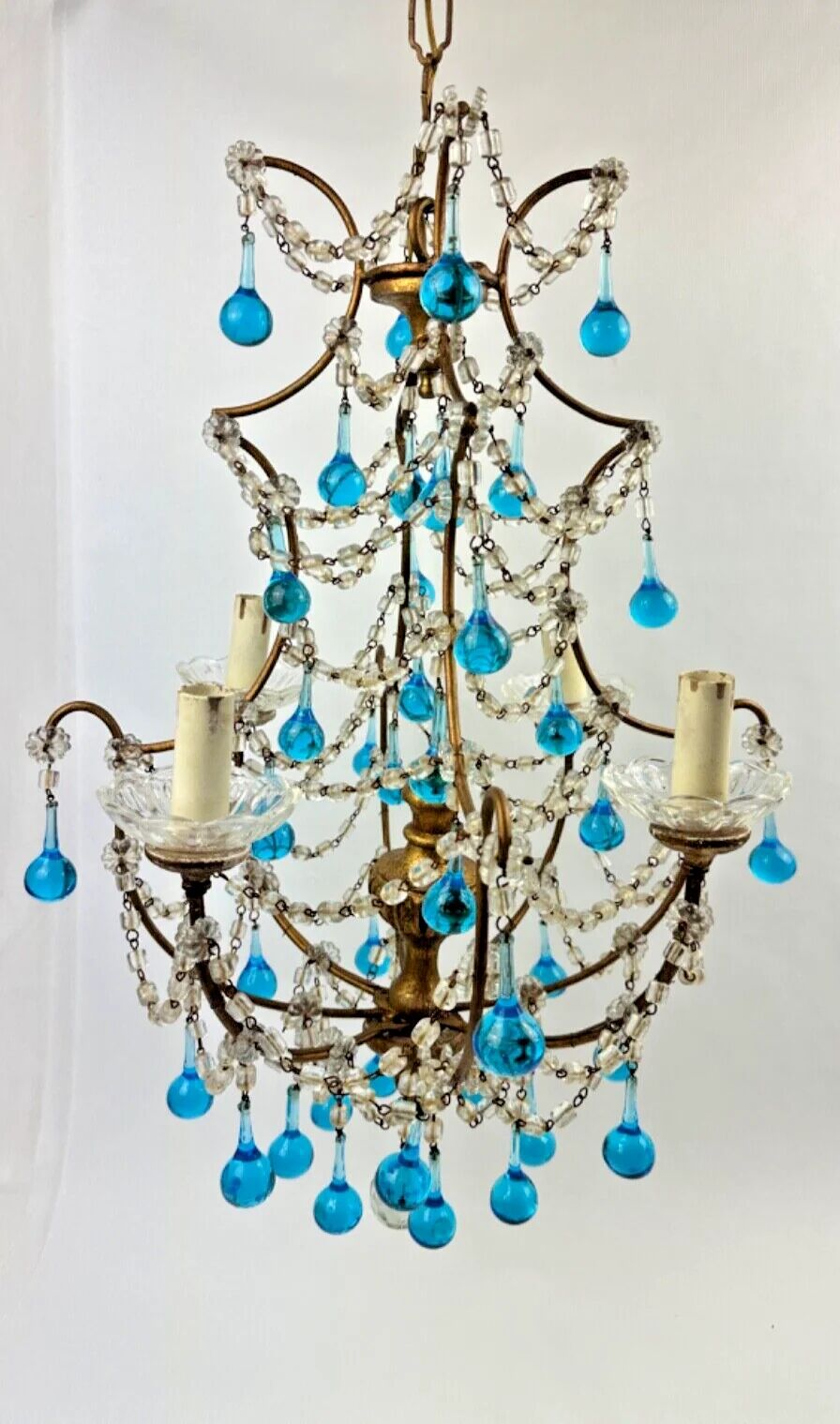 Italian chandelier with blue beads and gilded wood.