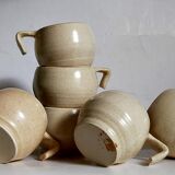 Six vintage potter's ceramic cups with vanilla enamel