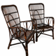 Pair of large dark rattan armchairs with high backs.