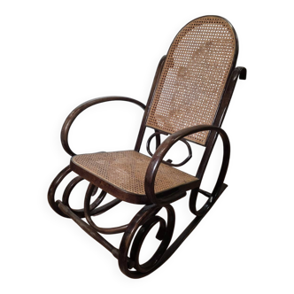 Curved wooden rocking chair with caning