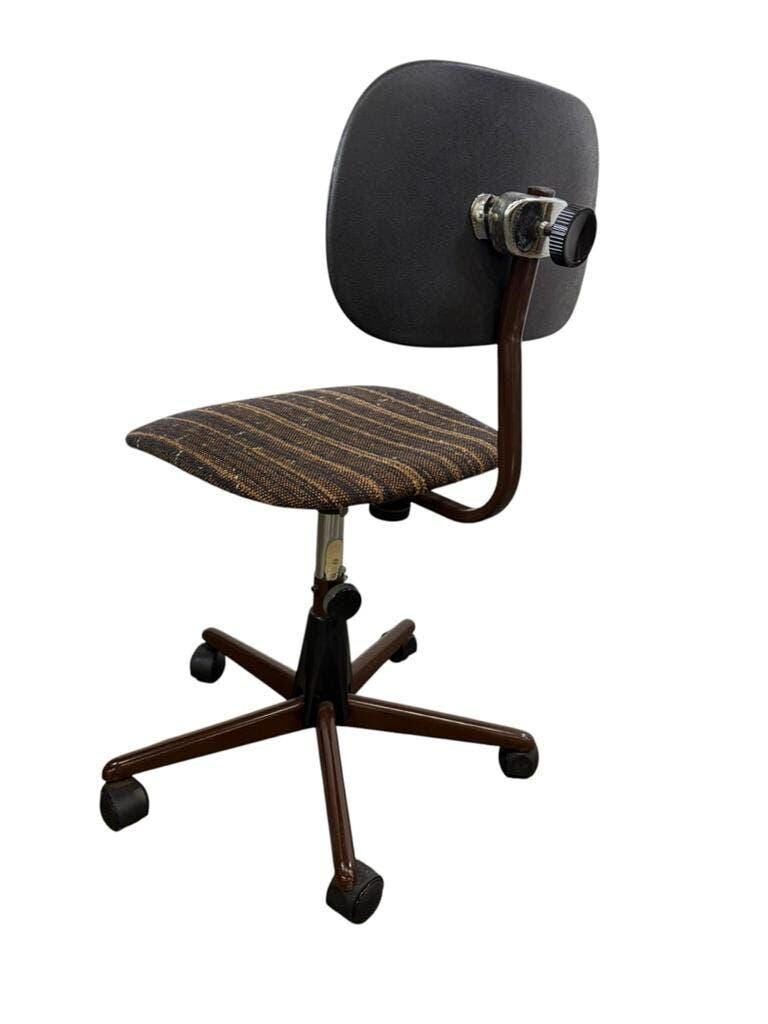 Brown vintage office chair from the 70s on wheels.