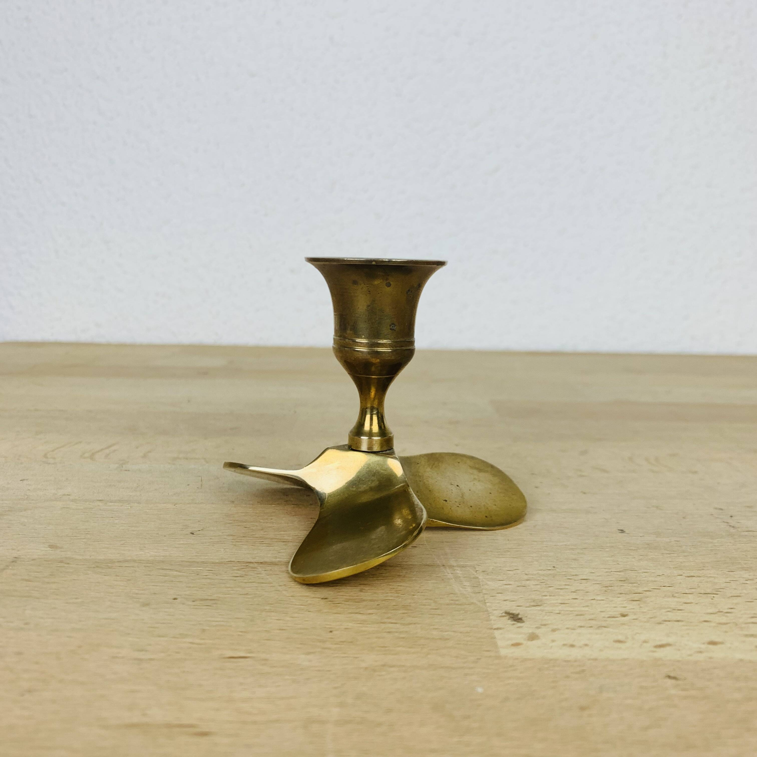 Golden brass propeller candle holder