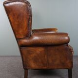 Dark wingback armchair made of sheep leather with stunning colors