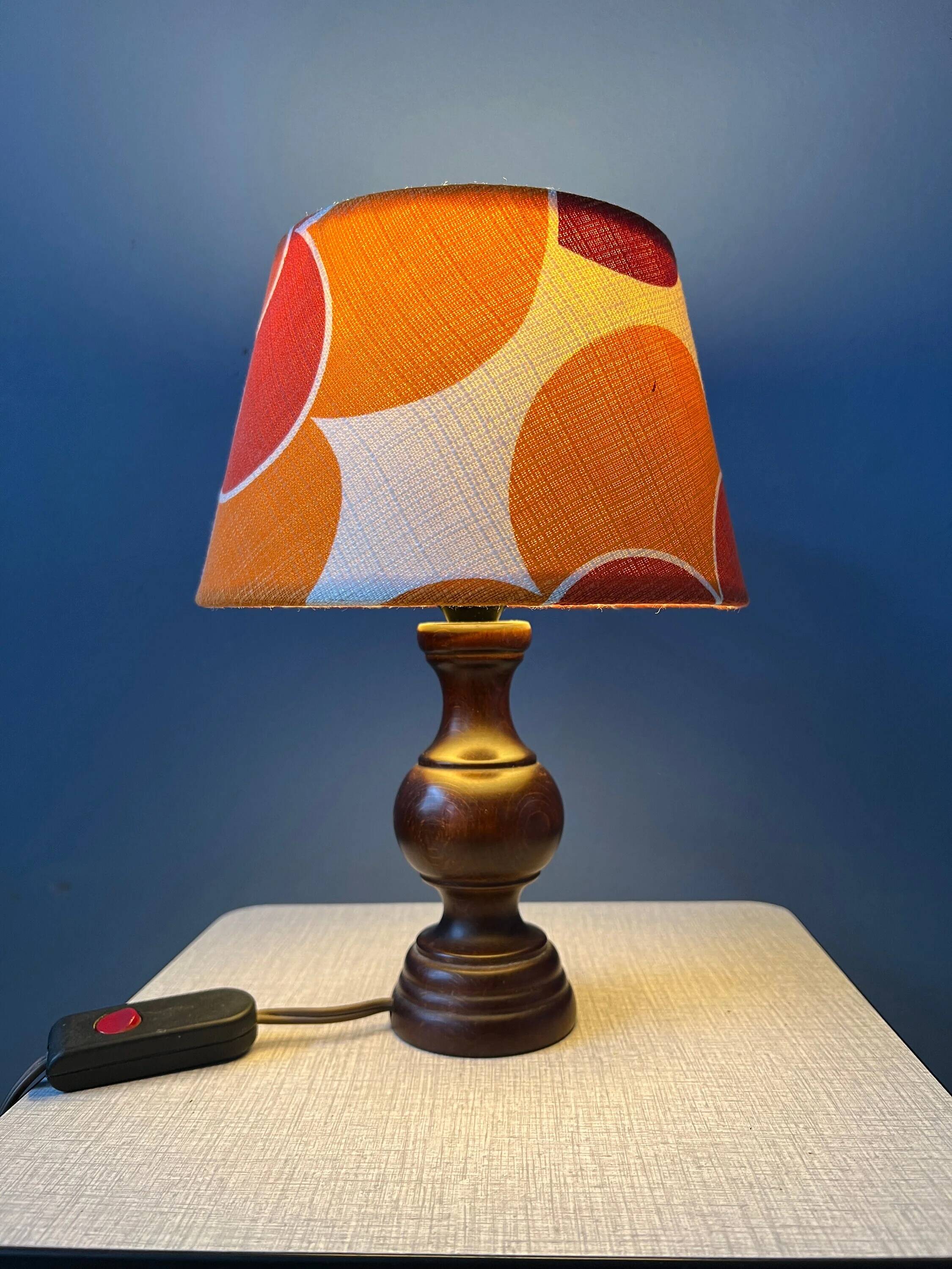 Vintage Space Age table lamp with orange fabric shade.