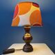 Vintage Space Age table lamp with orange fabric shade.