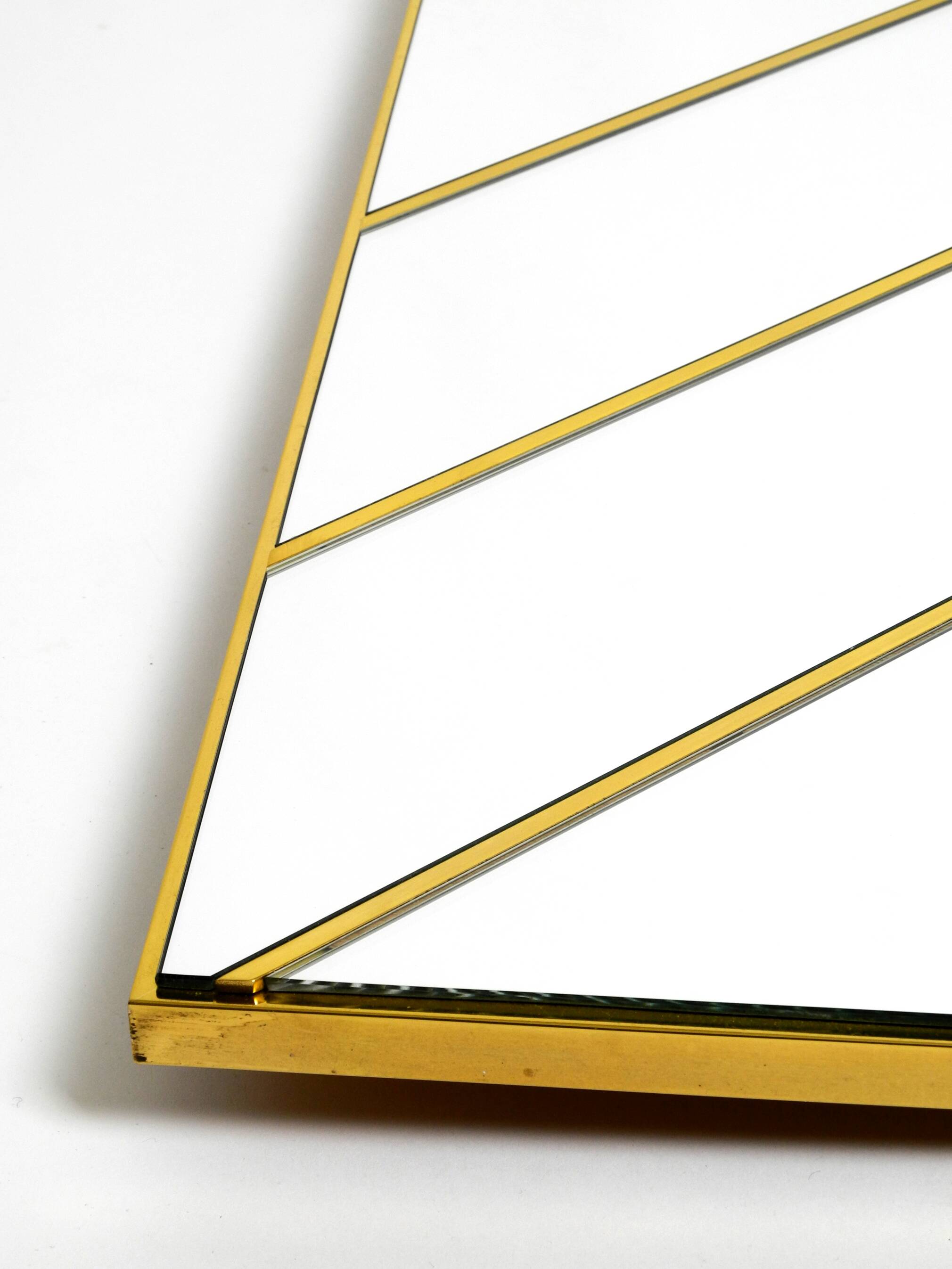 Large, exceptional 1970s brass wall mirror with diagonal mirror strips