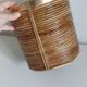Rattan and brass pot cover