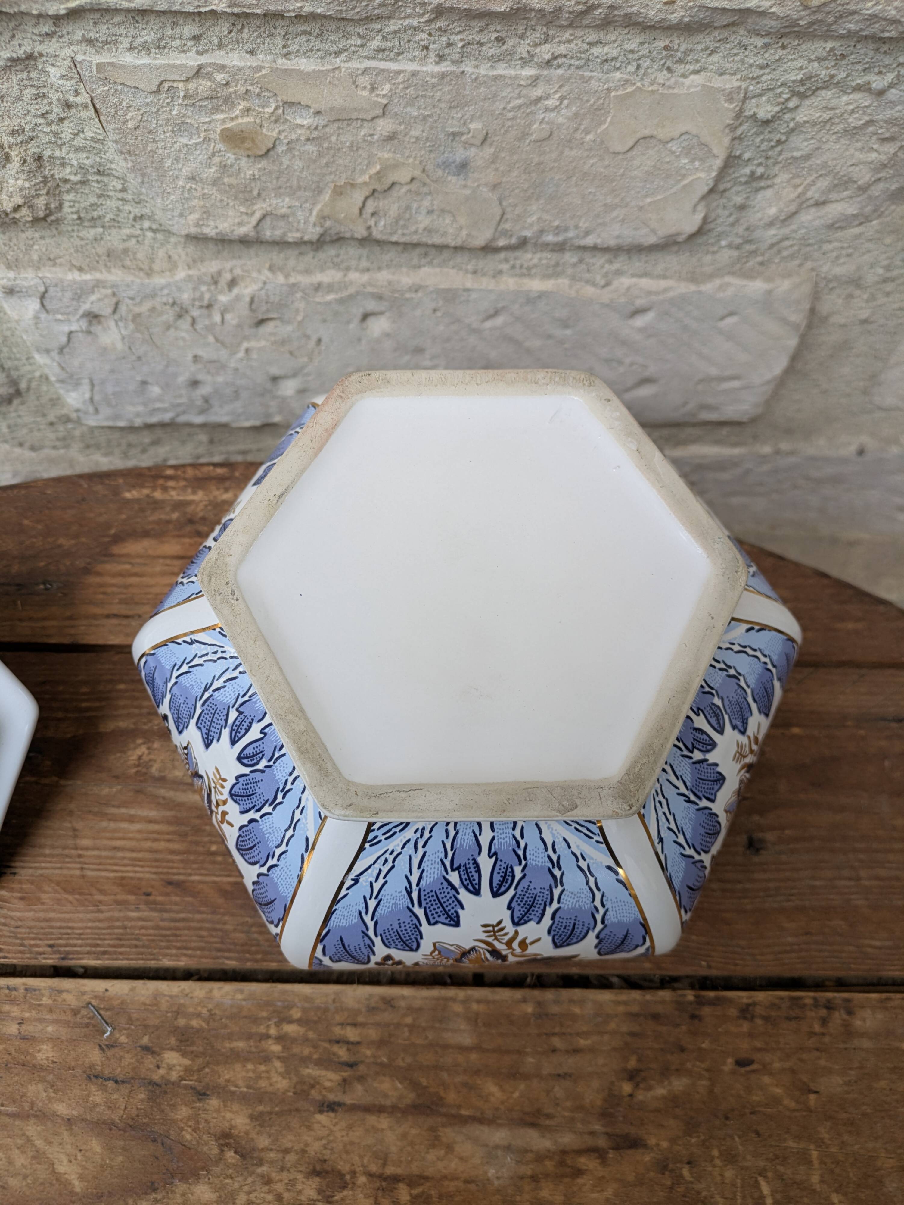 Decorative pot jar with a lid featuring a blue floral pattern and gilding.