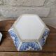 Decorative pot jar with a lid featuring a blue floral pattern and gilding.