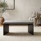 Minimalist/industrial coffee table with a black metal frame and a grey fabric top.