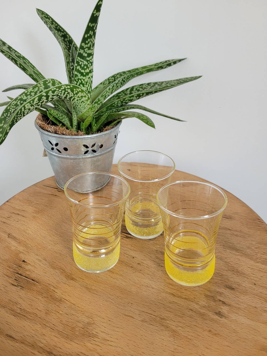 Trio of small yellow granite glasses with gold rims