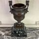 Patinated bronze vase with handles topped by bicéphalic busts, 19th century.