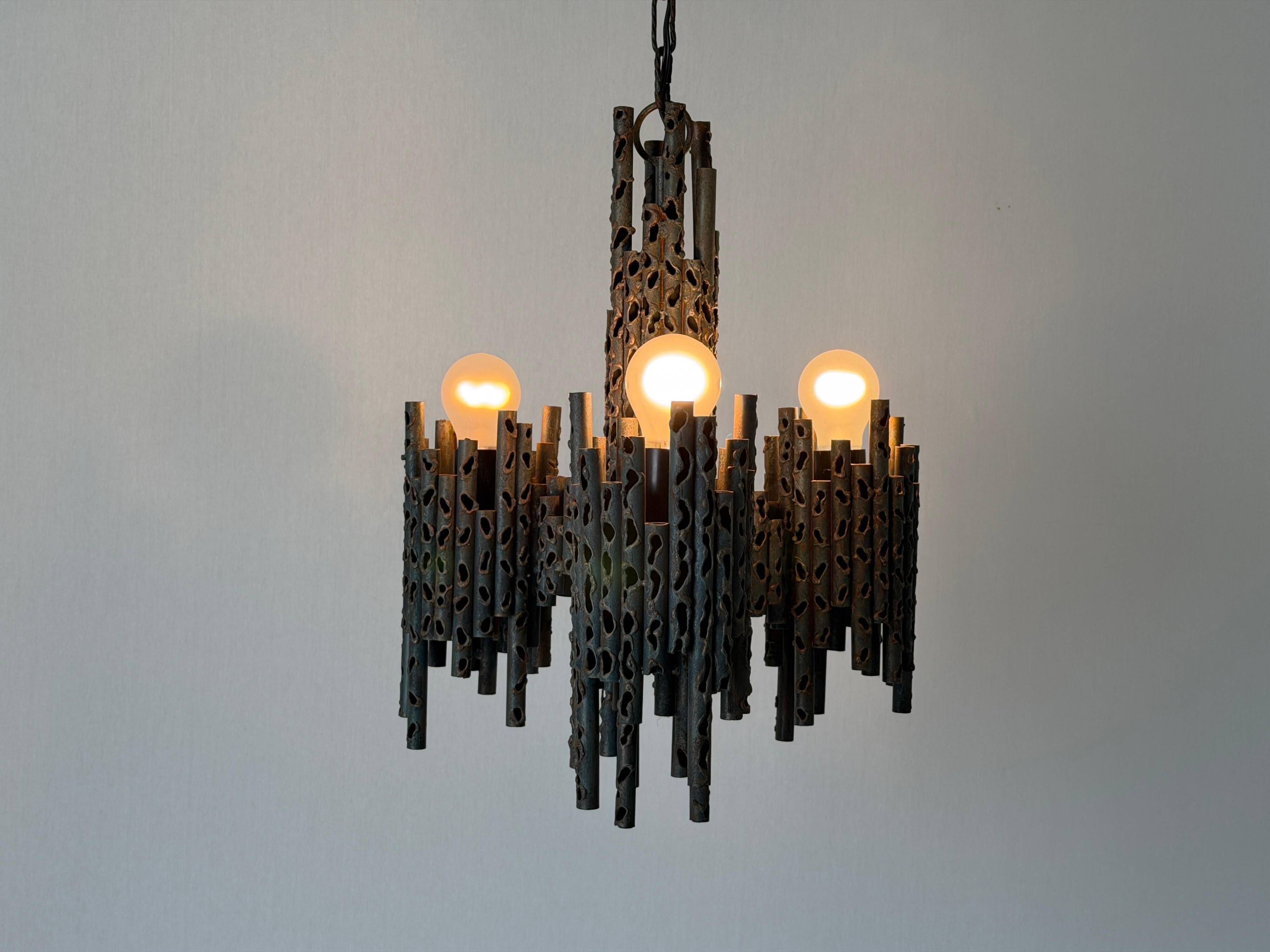 Three-armed suspended lamp in wrought iron, brutalist design, 1960s, Italy.