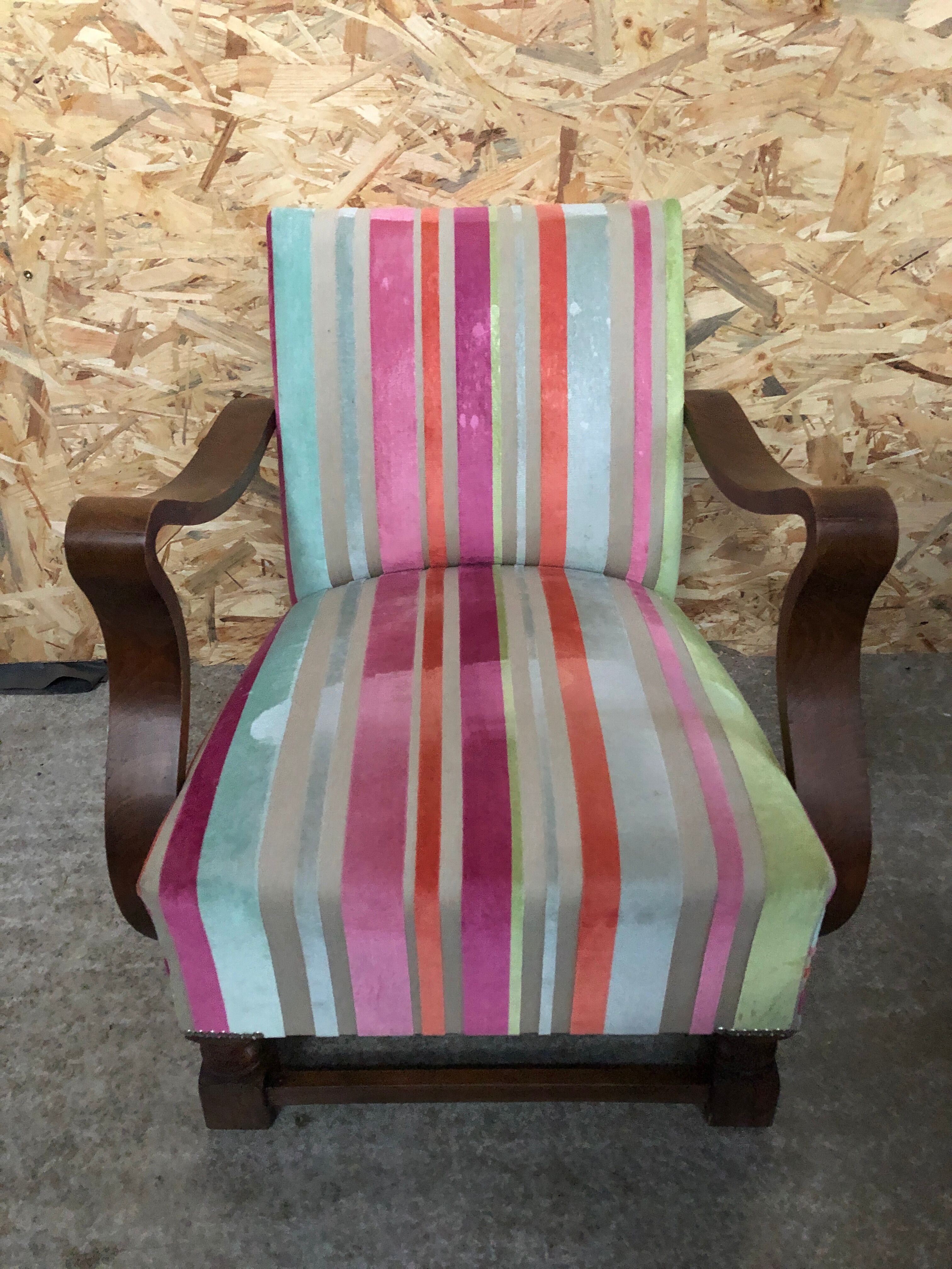 Old wooden armchair with curved armrests