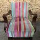 Old wooden armchair with curved armrests