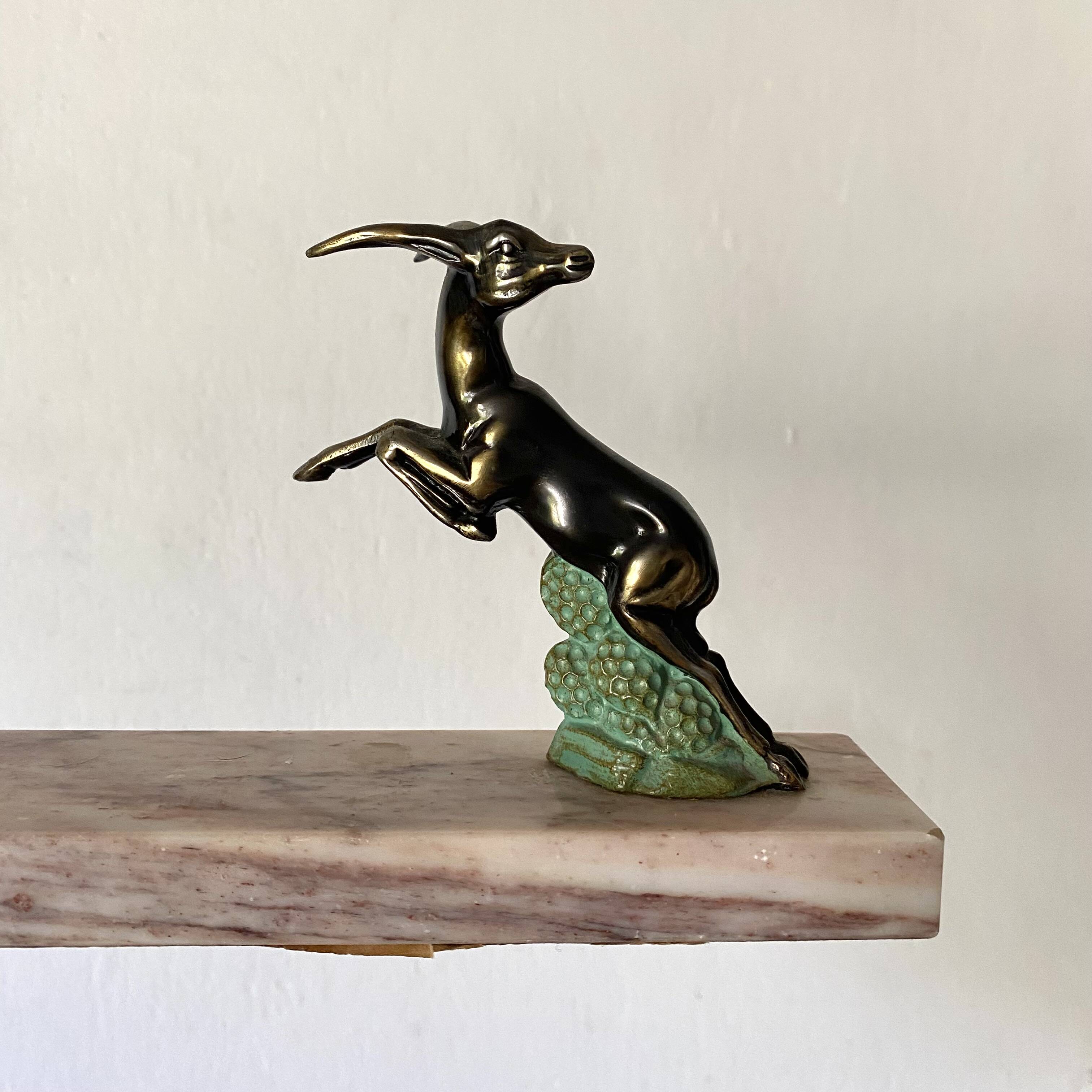 Art deco bookends in pink marble and spelters, antelopes