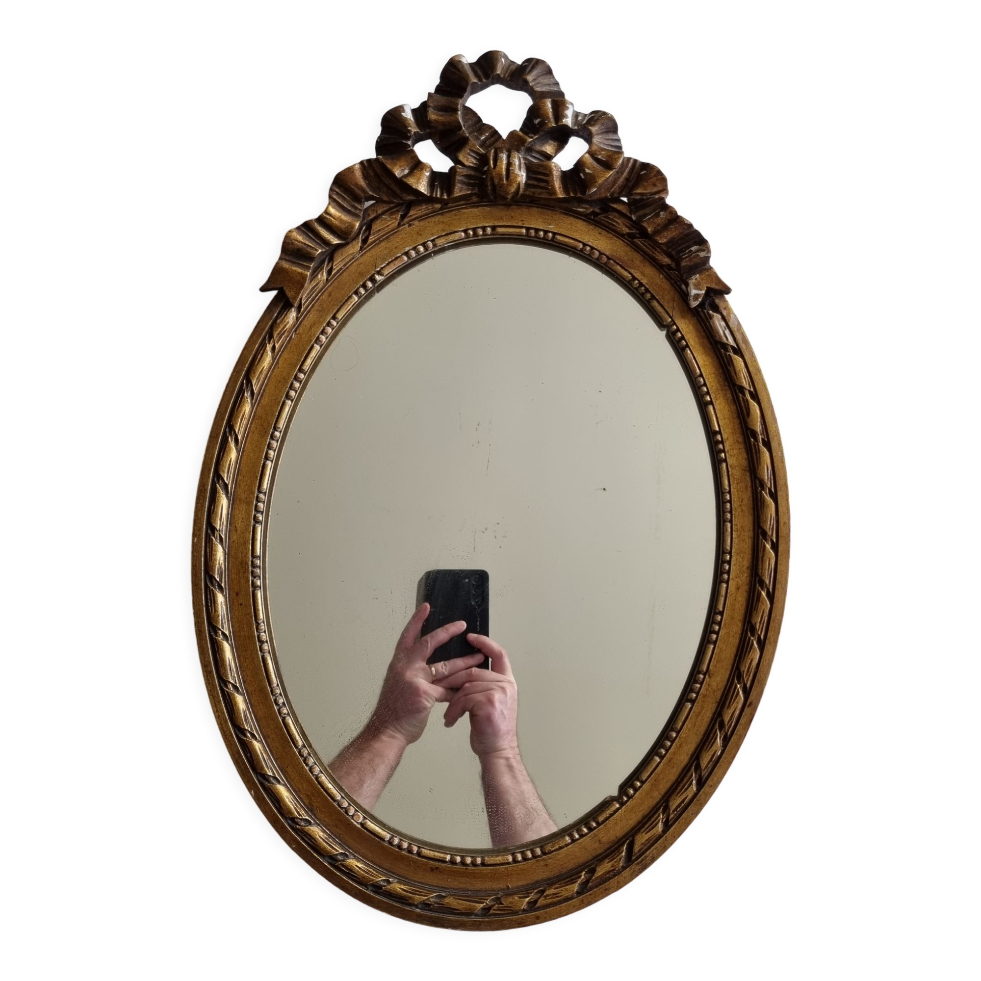 Louis xvi style oval mirror decorated with ribbons