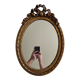 Louis xvi style oval mirror decorated with ribbons