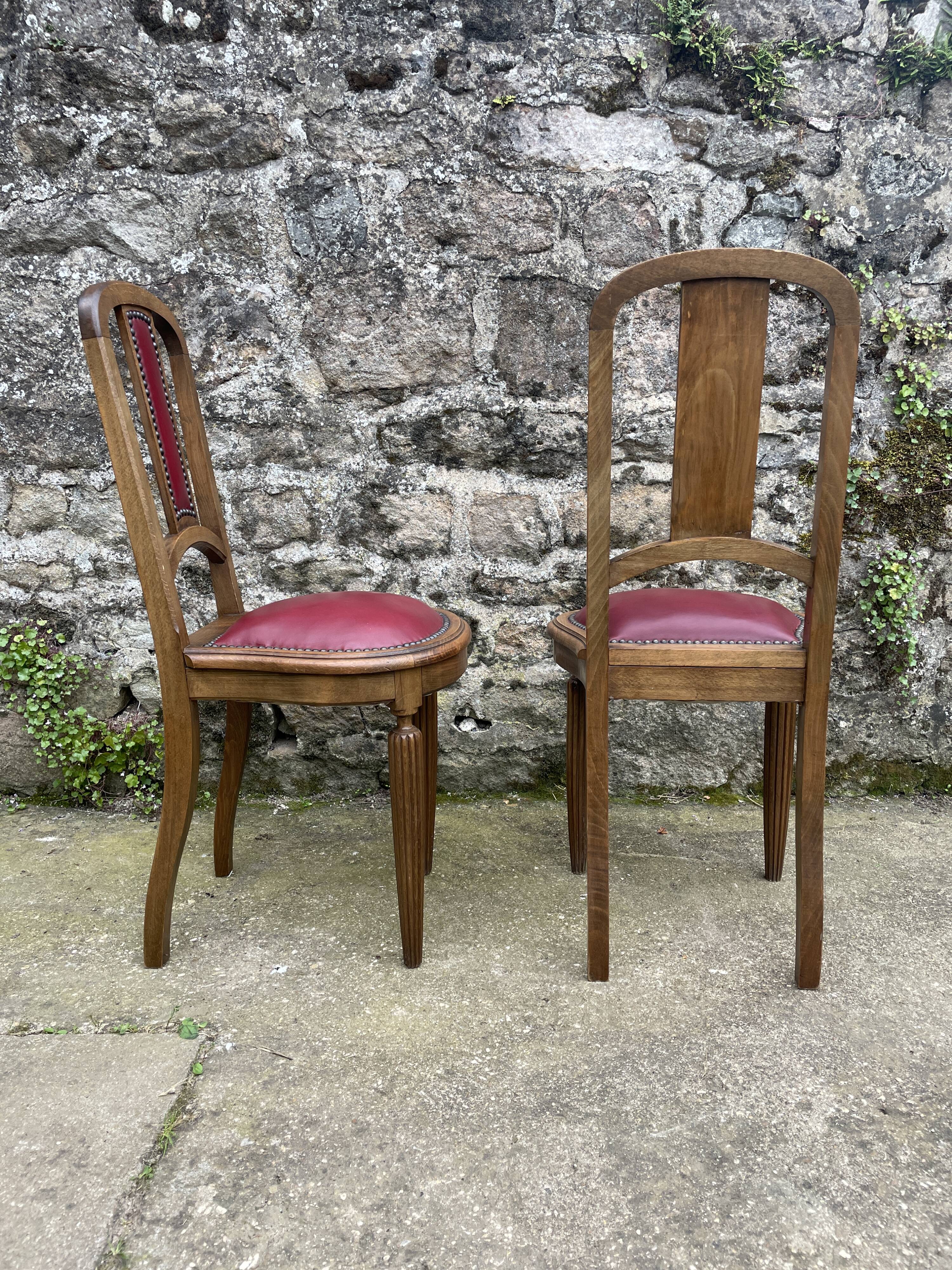 Pair of studded burgundy leather Art Deco chairs