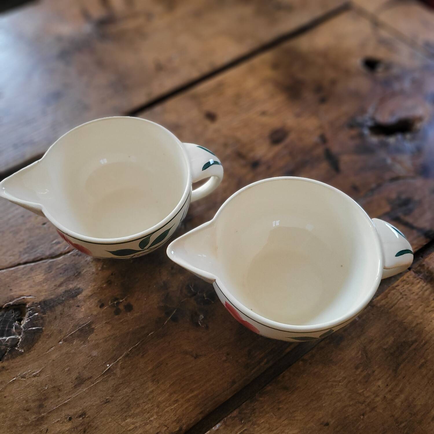 Pair of hand-painted floral-decorated jugs